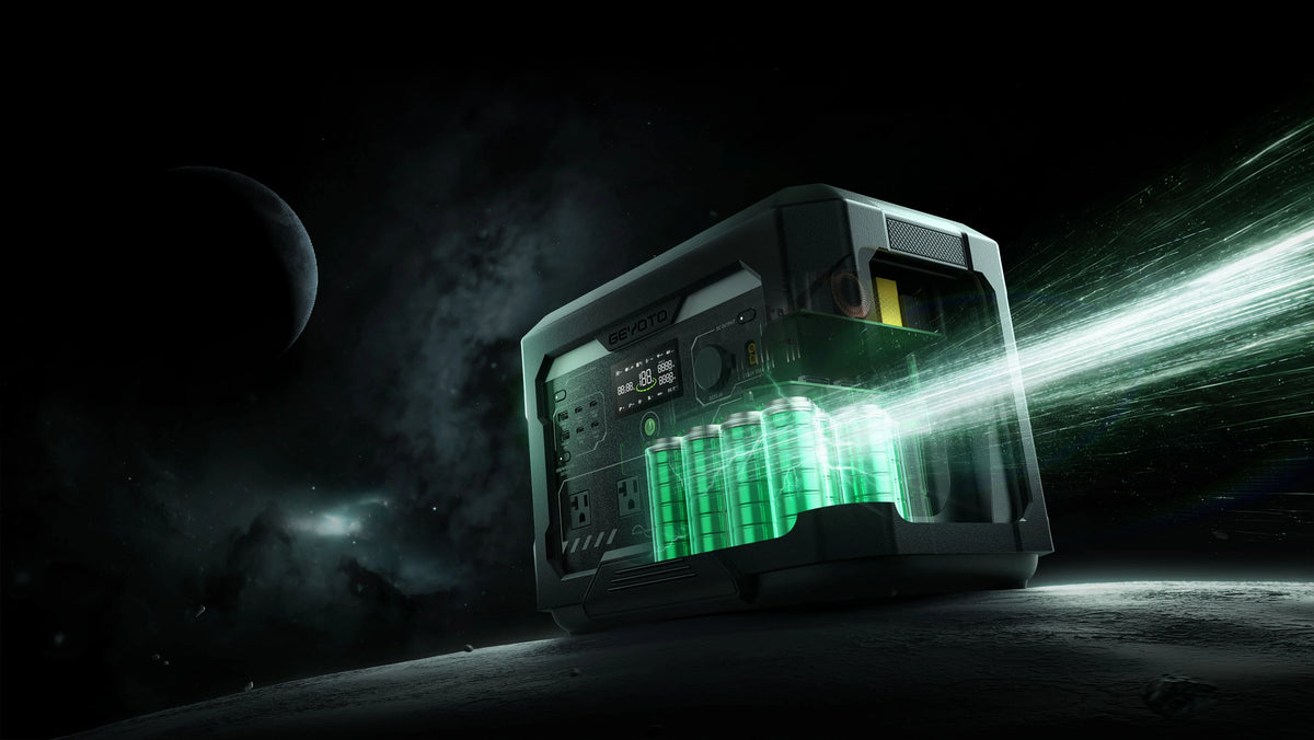 A portable power station with a dark gray metallic body and glowing green battery cells, shown on a dark sci-fi planetary surface with a planet in the background and a bright green beam of light projecting to the right.